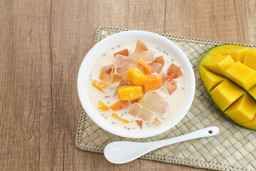 Mango Cheese Milk, a dessert made from jelly, nata de coco, basil seed, sweet mango, cream cheese and milk.
