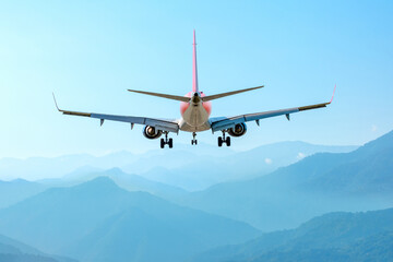 airplane fly above amazing blue misty mountains, jet flight travel concept