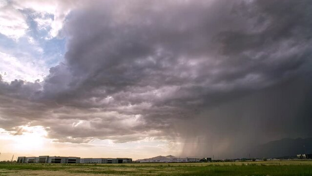 Time lapse of thunder storm moving through Utah Valley as sun peaks through the clouds as they roll following the rain.