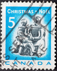 CANADA - CIRCA 1968: a postage stamp from CANADA, showing a sculpture Eskimo Family (carving)....