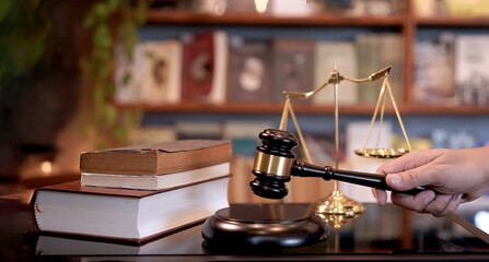 Lawyer or judge's hammer in the court. Auction's hammer is on woo table. Law subject or auction...