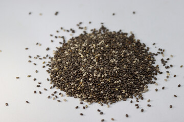 Selective focus on Chia seeds isolated with white background. Selective focus on Salvia Hispanica L.seeds protein rich diet Food ingredient.