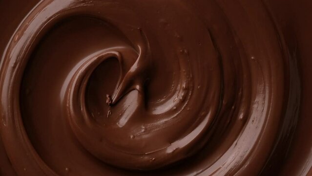 Zoom footage liquid dark chocolate top view. Confectionery concept