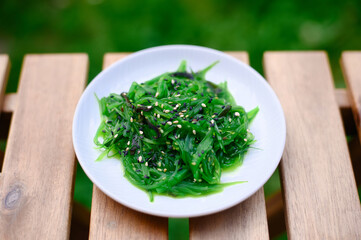 Obraz na płótnie Canvas Seaweed japanese chuka salad garnished with sesame seeds