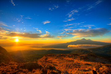Volcanoes Iztaccihuatl and Popocatepetl seen from top Mount Tlaloc in Mexico central at sunrise