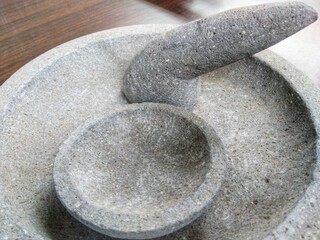 Fototapeta na wymiar Traditional mortar and pestle made of stone for grinding spices
