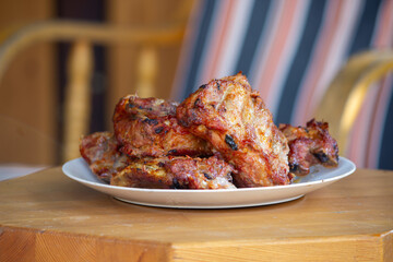 Barbecue pork ribs served on a plate. Side view