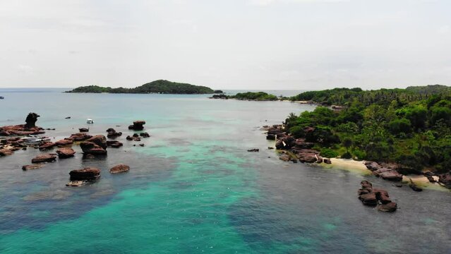 Rocky Wild Coast at Gam Ghi Small island in Vietnam Archipel Surrounded by Clear Turquoise Waters and Colored Coral Reefs, Aerial view of Phu Quoc South Region
