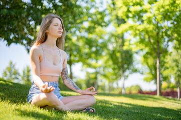 Girl practice yoga meditation outdoor in park