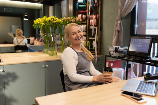 Flower Shop Employee Resting While Waiting For Customers