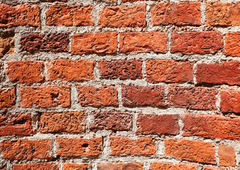 Old brick wall, texture grunge background. Dark red brick wall eroded by time and natural brick texture. Idea for advertising, banner or product article