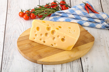 Maasdam cheese piece over board