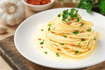 A plate of spaghetti AGLIO E OLIO on a board close-up