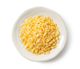 Tenkasu served on a plate placed on a white background.