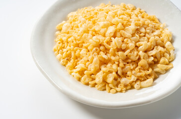 Tenkasu served on a plate placed on a white background.