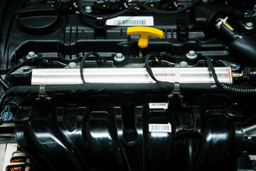 Bright yellow dipstick handle for checking the engine oil level