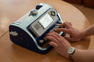 Blind man using braille typewriter. 