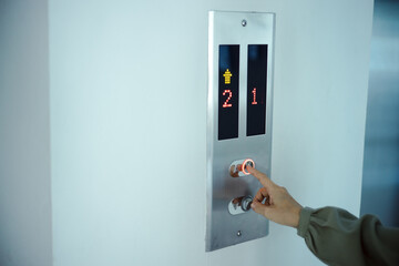 Press the elevator button inside the building. close up photo and focus on the button