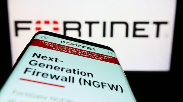 Stuttgart, Germany - 07-03-2022: Smartphone with webpage of American cybersecurity company Fortinet Inc. on screen in front of business logo. Focus on top-left of phone display.