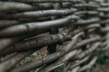 horizontal wicker wooden fence in the garden. Decoration, garden decor