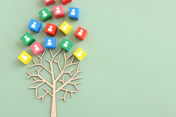 Business image of wooden tree with people icons over green background, human resources and...
