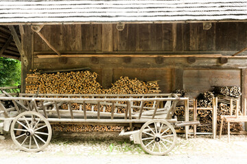 Fototapeta na wymiar A picture of wood cart and stacking cut wood at workshop.
