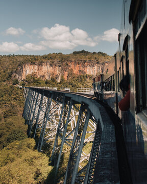 Burmese train, view taken from the open window while the train is approching the famous Goteik Viaduct in Shan State, Myanmar, on a sunny day with clouds.