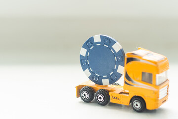 a toy truck with a poker chip on white background