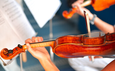 Two singers are signing at wooden violins inside a church. Violin music photo.
