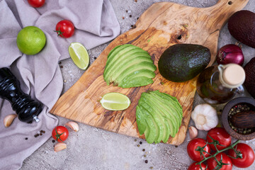 Sliced avocado on wooden cutting board at domestic kitchen