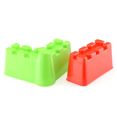Colored sand molds isolated on a white background, close-up. Molds for playing in the sandbox. Build sand castles. Development of children's motor skills
