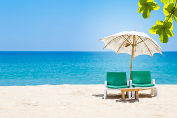 Beach chair with fabric umbrella on beautiful beach, relax by the sea, tropical summer holiday season