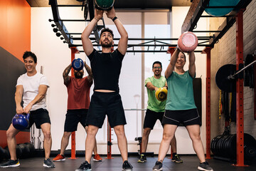 Group of beginners athletes exercising in a personal class with a private trainer. Various exercises