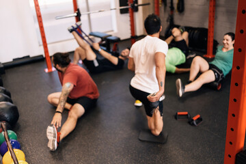 Group of beginners athletes exercising in a personal class with a private trainer. Various exercises. Blurred, anonymous