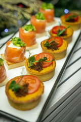 Small salmon snacks on white dishes
