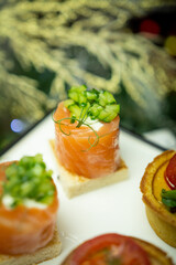 Small salmon snacks on white dishes