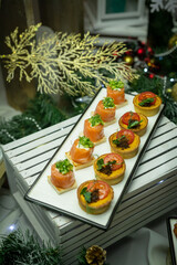 Small salmon snacks on white dishes