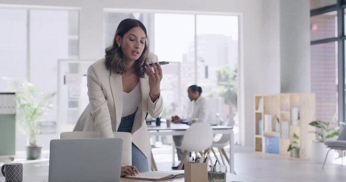 Business woman talking on a phone and writing notes. Creative designer and manager using loudspeaker on technology to network with a client or negotiate a deal. Arranging an employee review meeting
