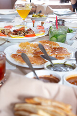 A view of a long table full of a variety of Persian entrees.