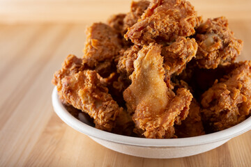 A view of a bowl of deep fried chicken wings.