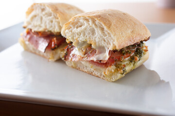 A closeup view of an Italian deli meat sandwich.