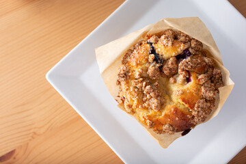 A top down view of a blueberry muffin.