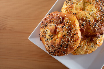 A top down view of a plate of everything bagel style scones.