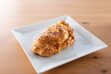 A view of a savory pastry or stuffed pocket appetizer.