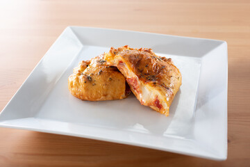 A view of a savory pizza pocket appetizer.