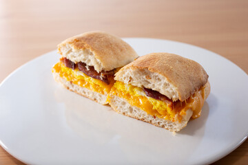 A view of a breakfast sandwich, featuring a ciabatta roll.