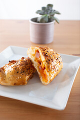 A view of a cut open ham and cheese pocket.