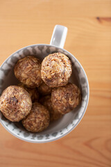 A top down view of a bowl of date energy balls.