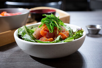 A closeup view of a sashimi salad bowl.