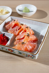 A view of a plate of seared salmon sashimi.